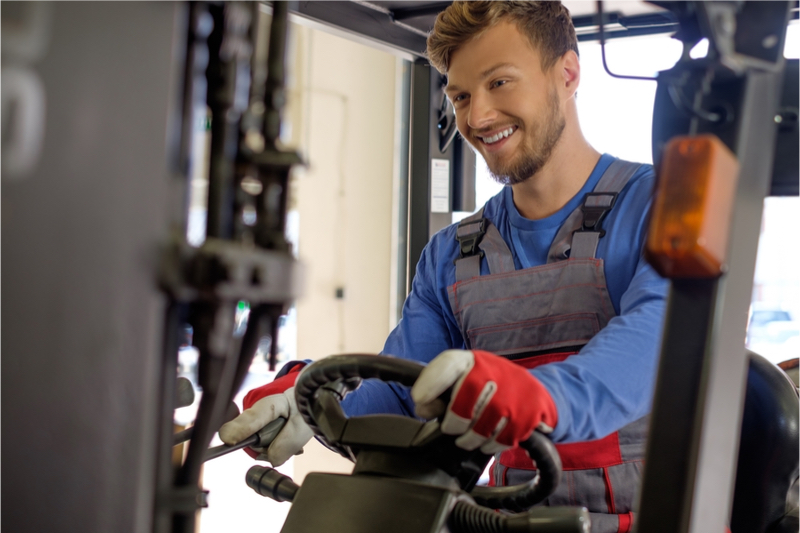 Man using gloves to drive forklift